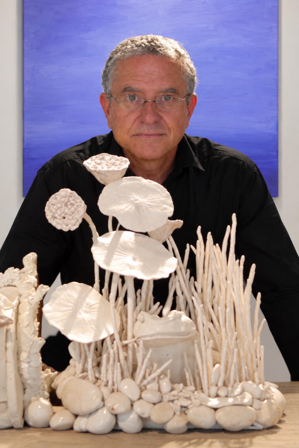 Larry Deep with his white porcelain sculpture and Purple Solitude behind him